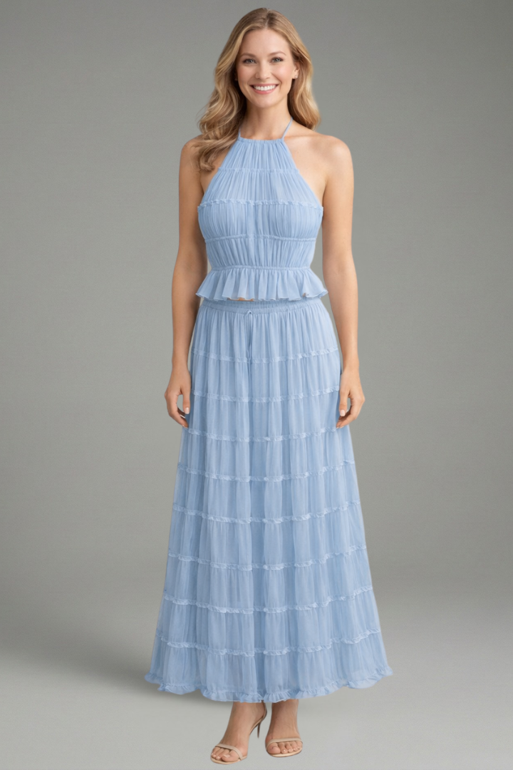 Woman model front pose on top and skirt, plain gray background