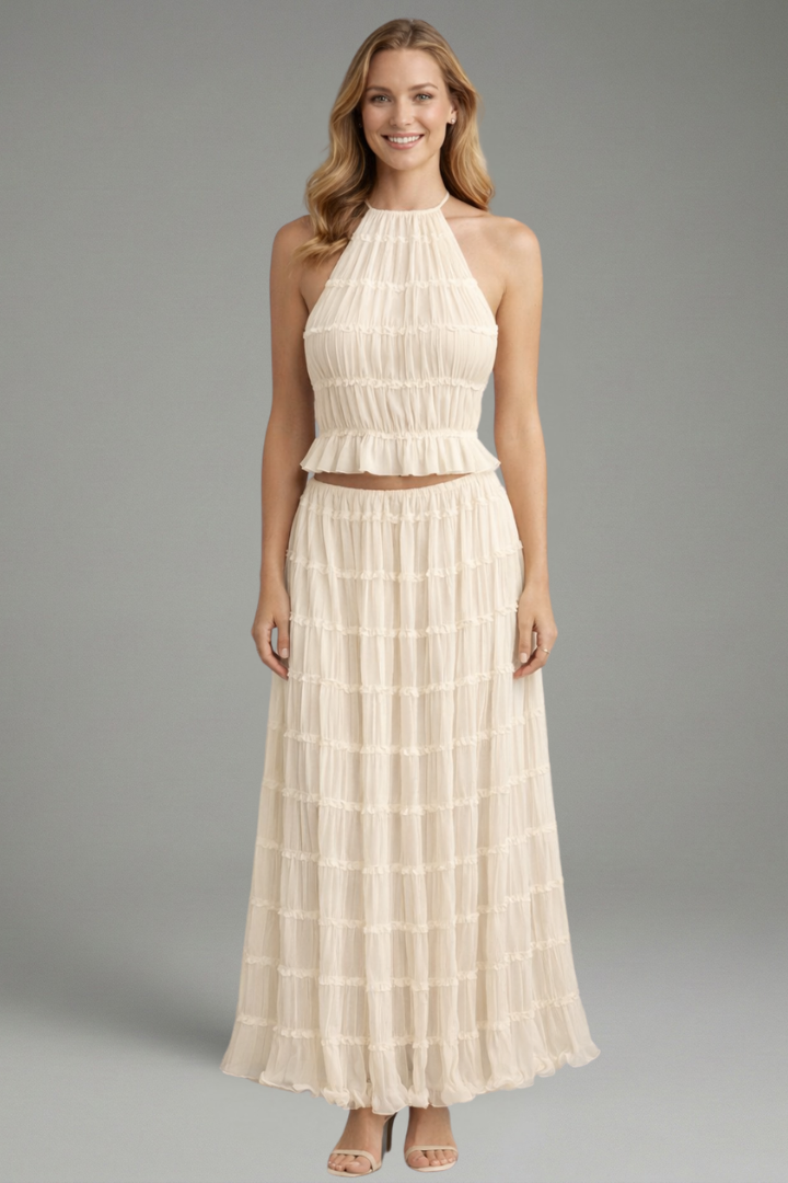 Model wearing pleated set on gray background
