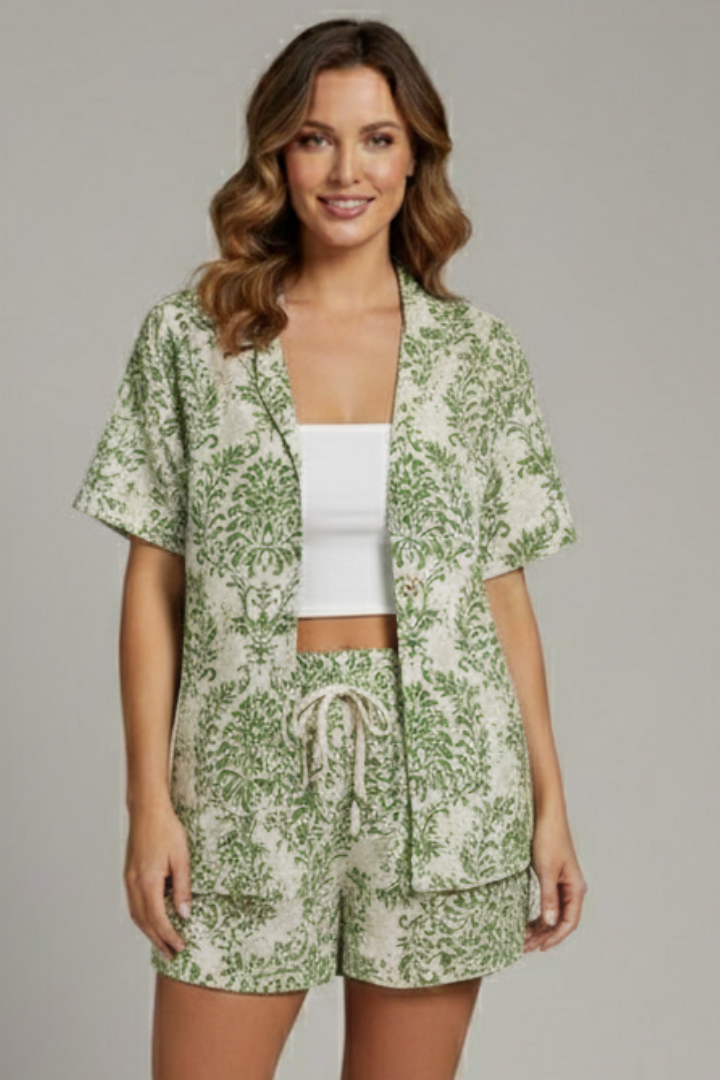 Woman posing casually in floral textured two-piece on gray.