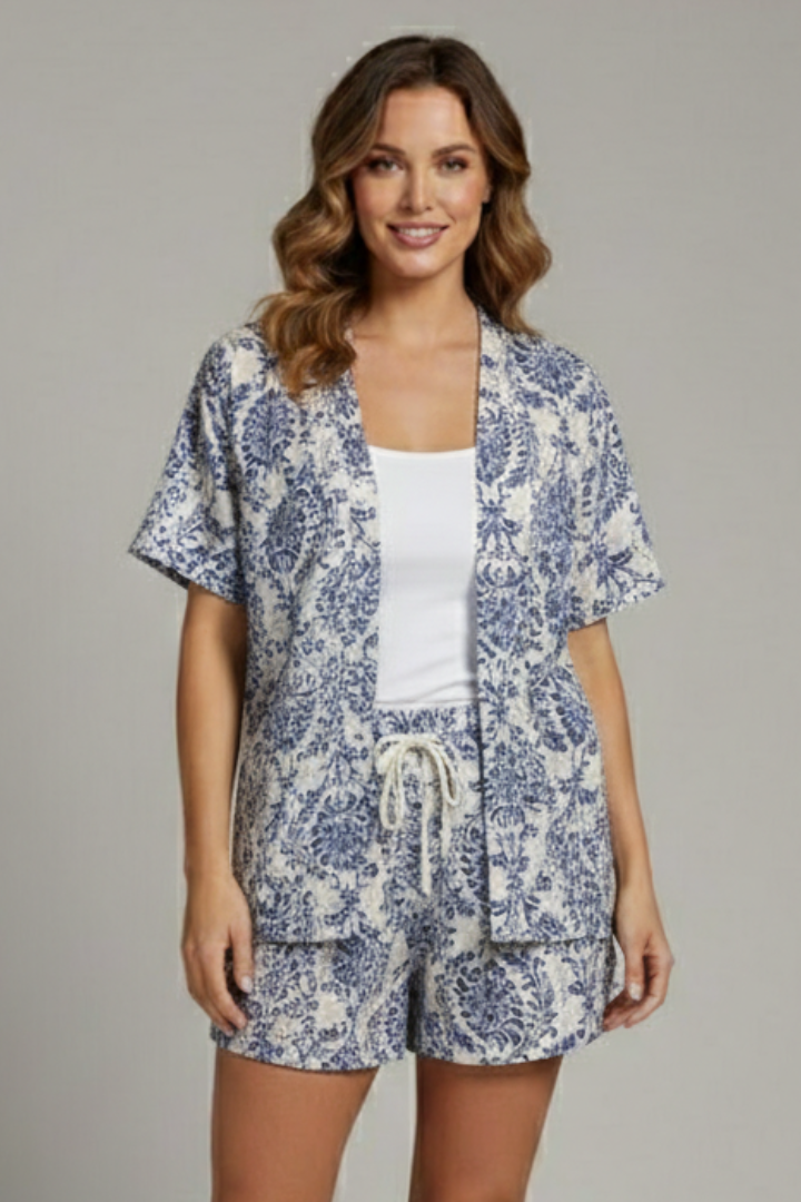 Female model in stylish floral lounge outfit, gray background.