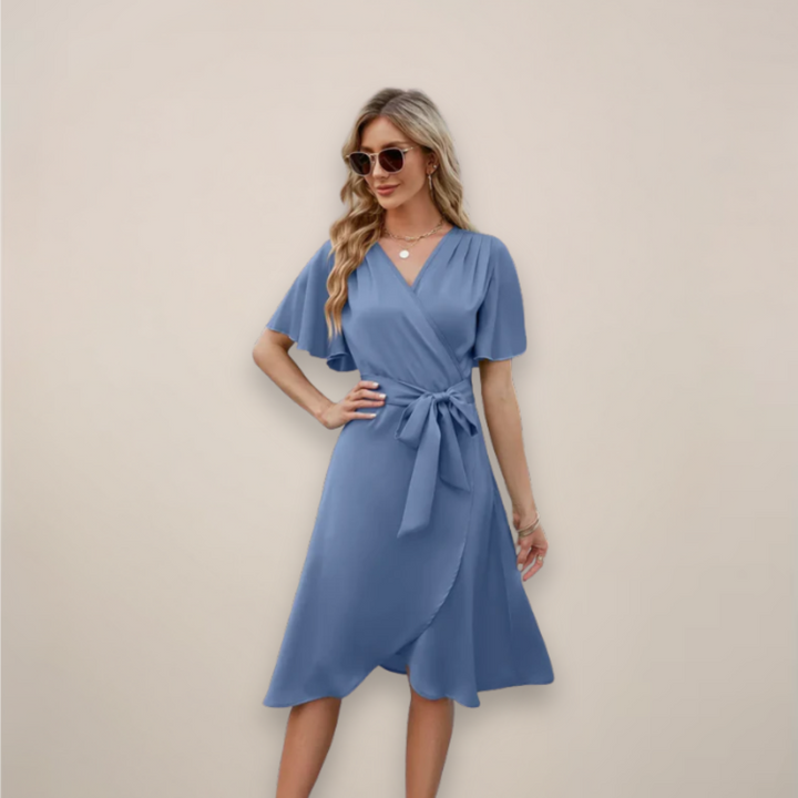 Female wearing a midi wrap dress with V-neck design and tie waist on a plain background.