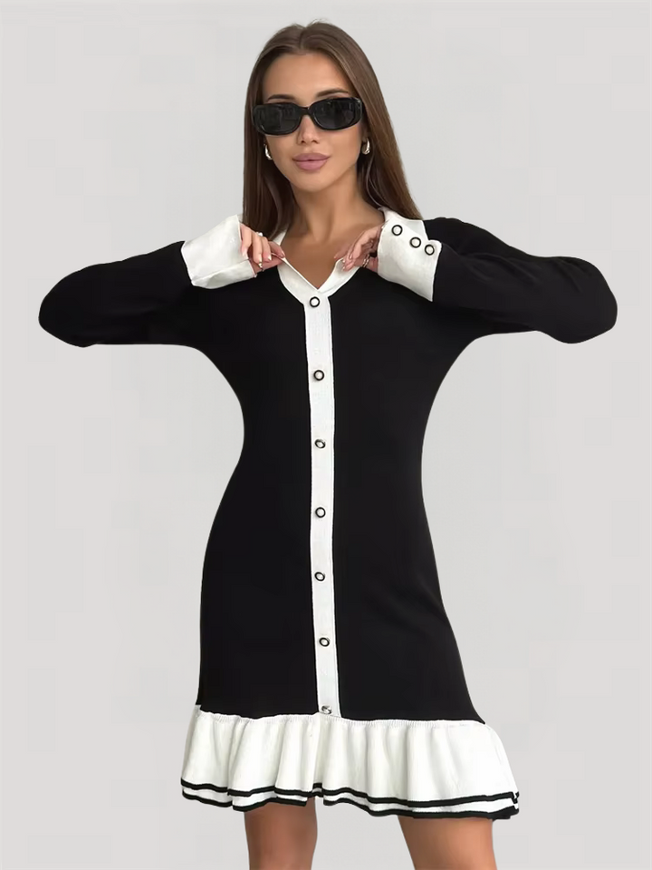 Female model in a ribbed knit dress with collar, front buttons, and clean trim on a plain background.