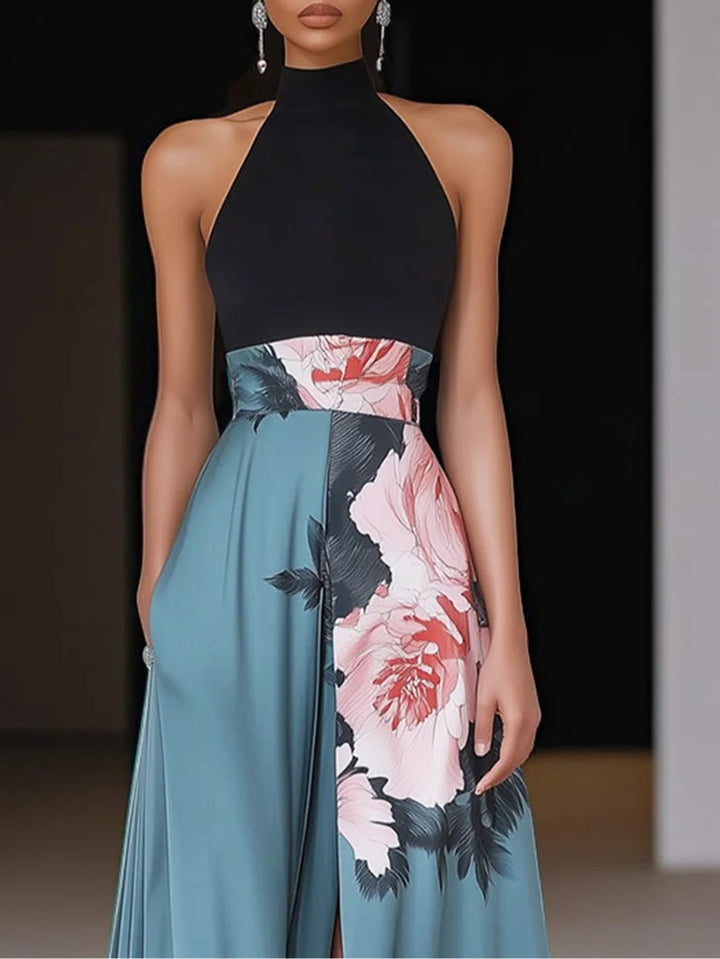 Female model wearing black floral maxi dress on plain background.