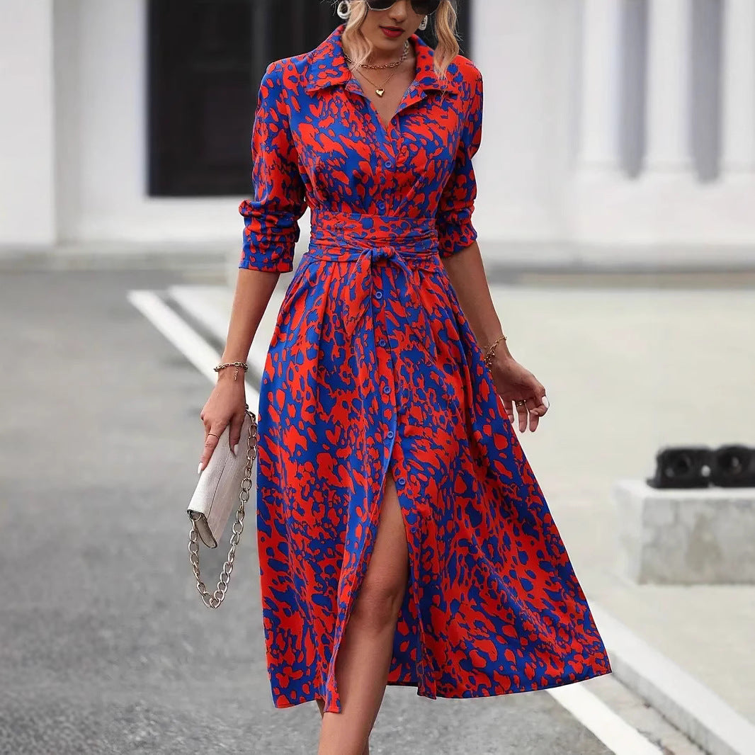 Woman wearing a button-front midi dress with a defined waist on a plain background.