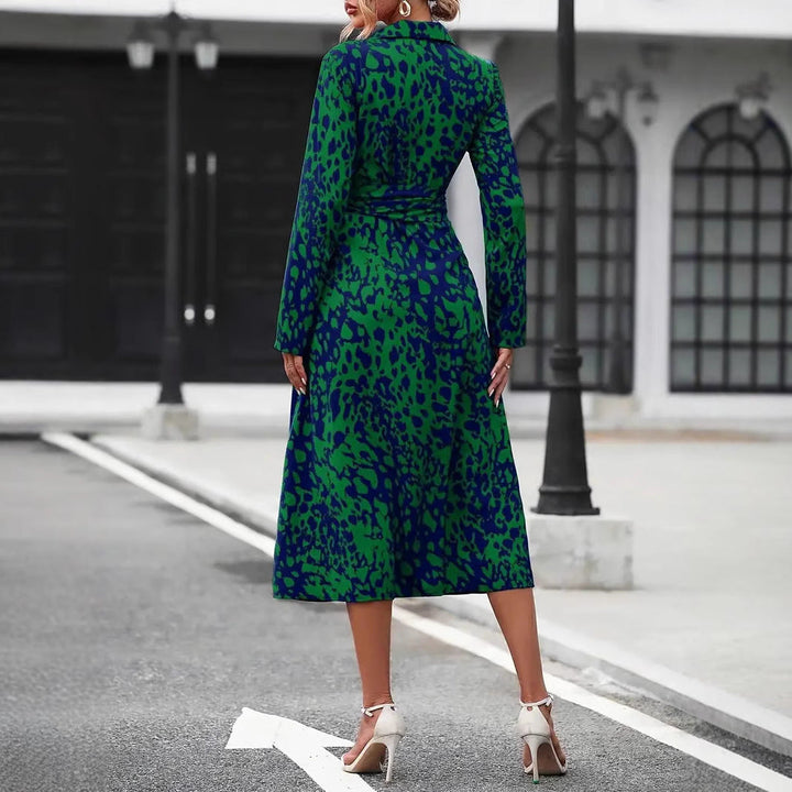Model wearing an A-line midi dress with midi length and waist tie on a plain background, back view