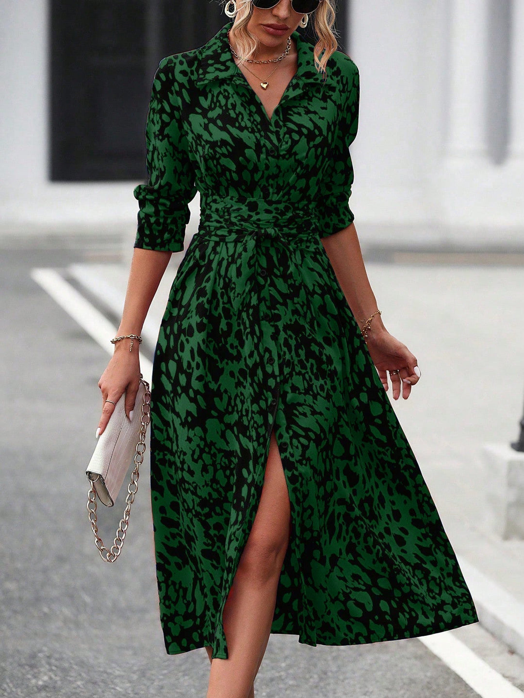 Model in a casual button-front dress with defined waist and everyday midi length.