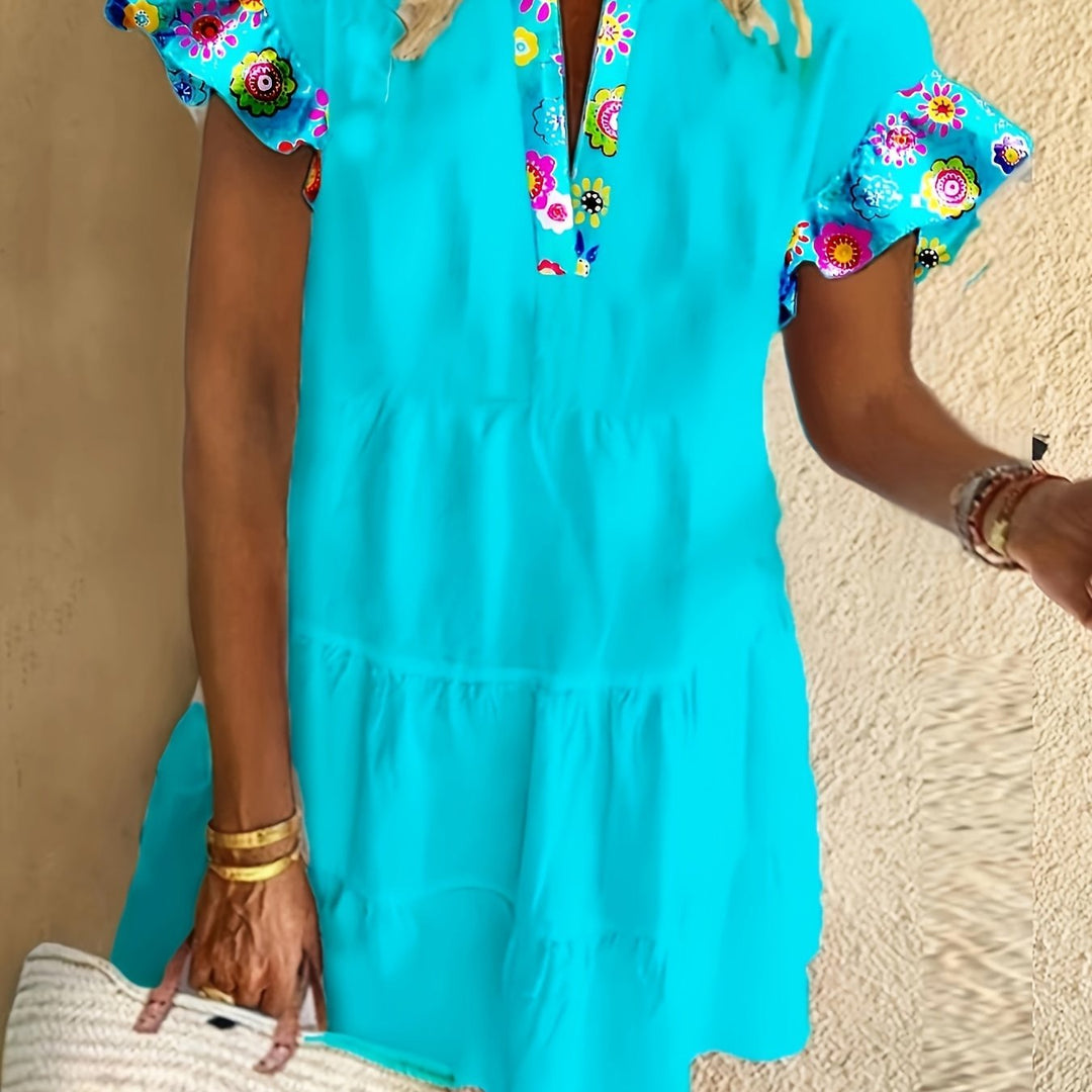 Woman wearing a flowy boho chic dress on a plain background.