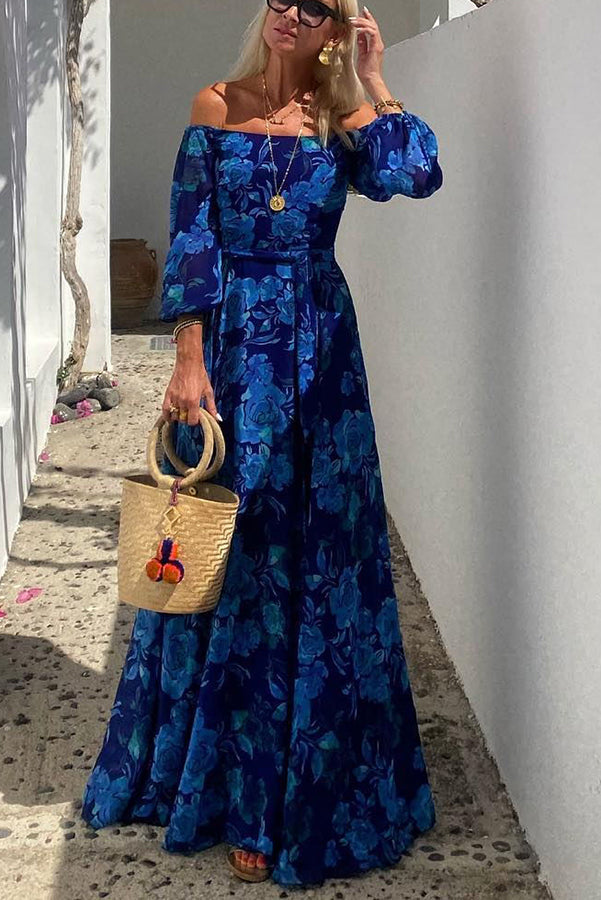 Female model in a floral off-shoulder maxi dress against a clean background.