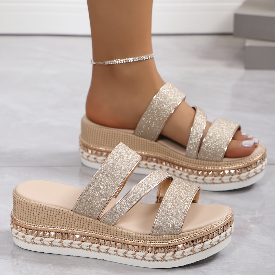 Female wearing supportive summer sandals on a plain background.