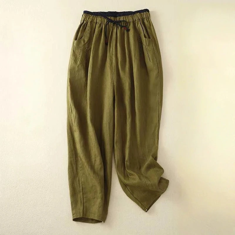 Female model wearing breezy wide-leg pants on a clean background.