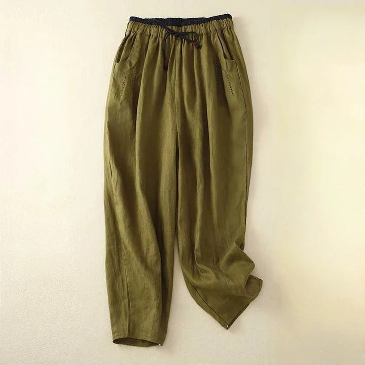 Female model wearing breezy wide-leg pants on a clean background.