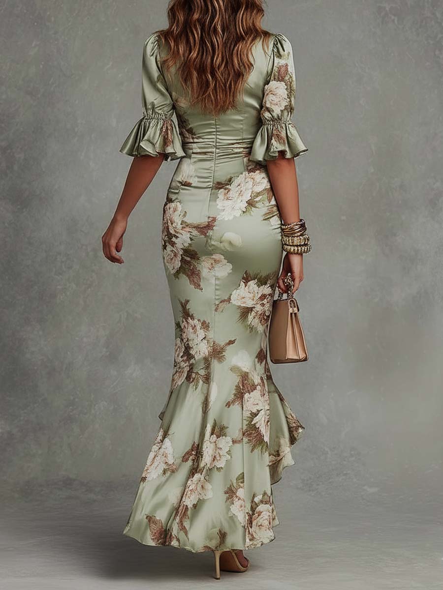  Woman wearing a sheer floral dress with refined detailing on a plain background.