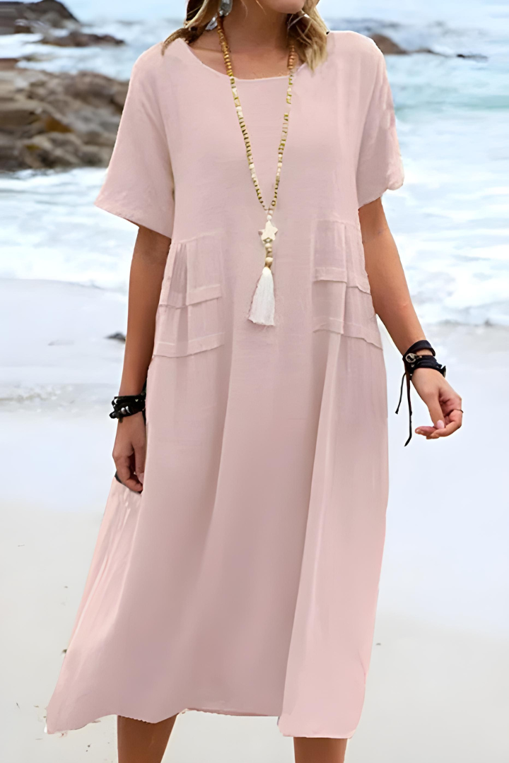  Woman wearing a timeless midi dress with an easy fit against a plain background.