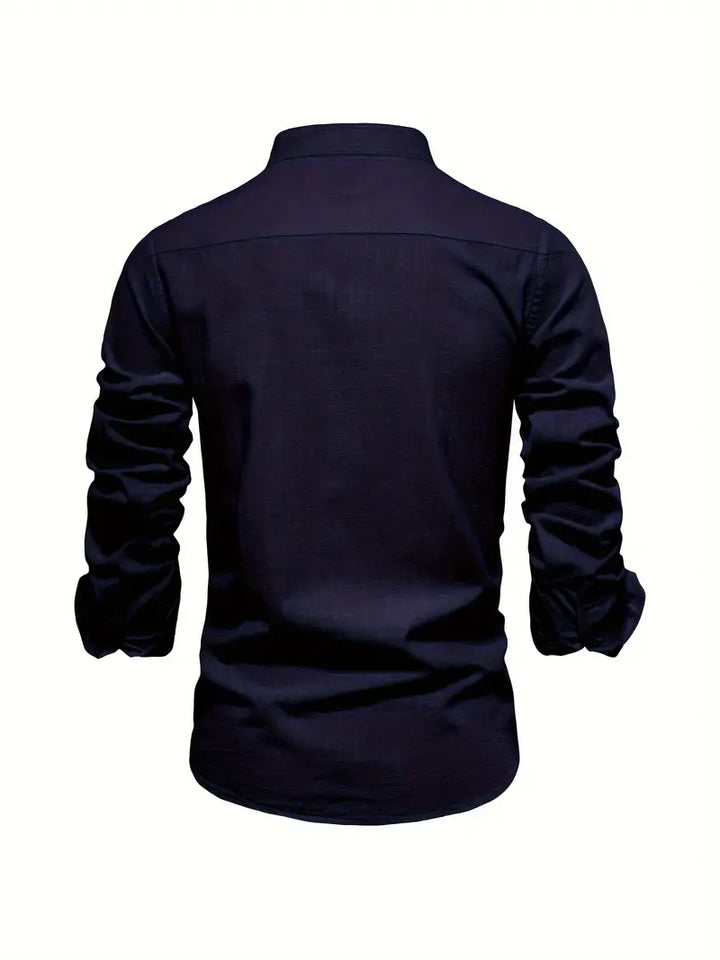 A collared button-up shirt with buttoned cuffs on a plain background.