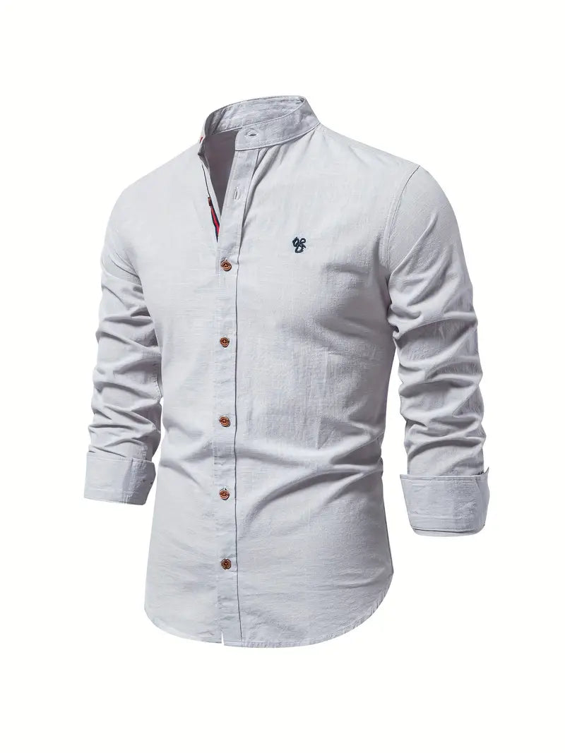 A neat long sleeve shirt with a full button front on a plain background.