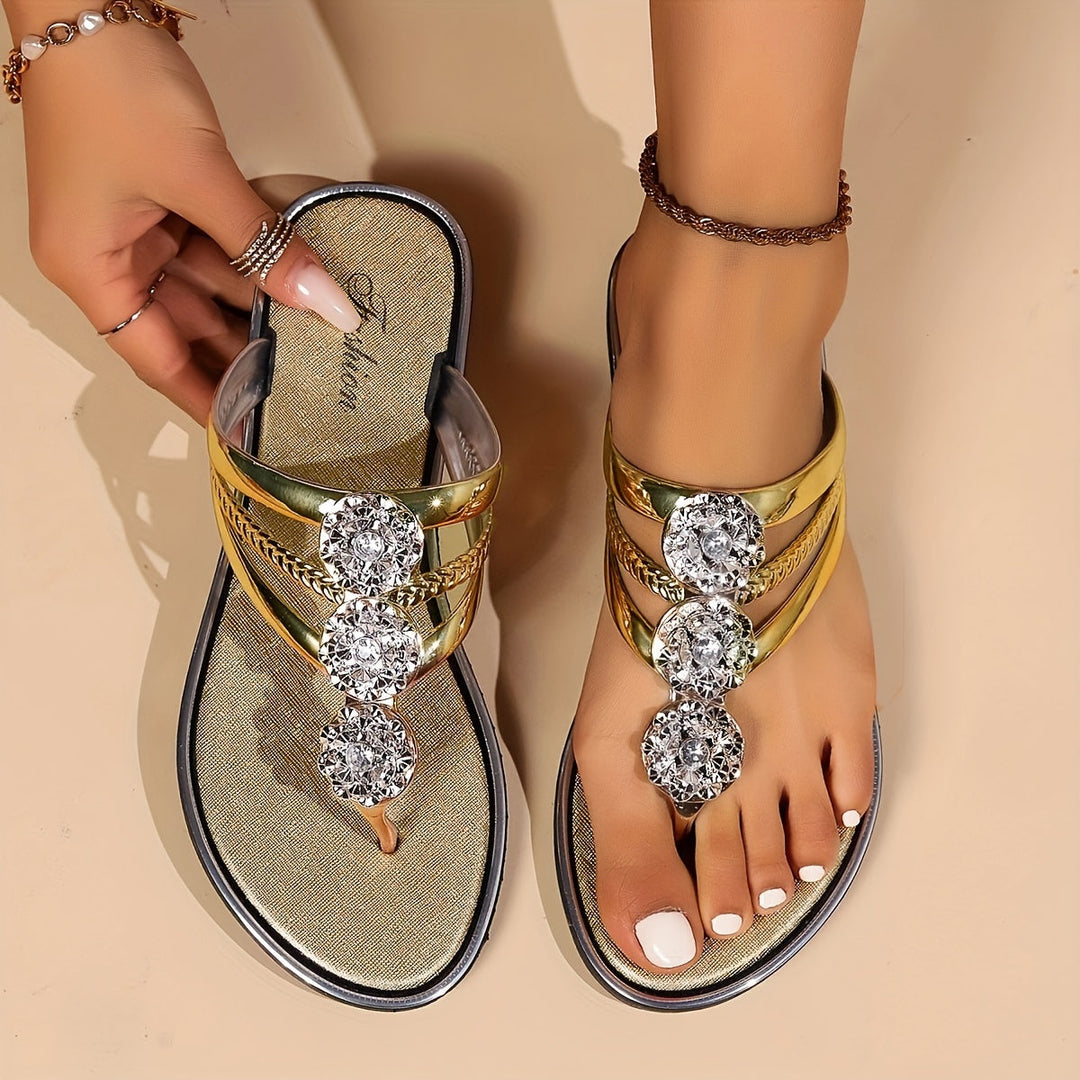 Model feet showcasing open-toe rhinestone sandals against a plain background.