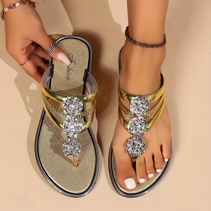 Model feet showcasing open-toe rhinestone sandals against a plain background.