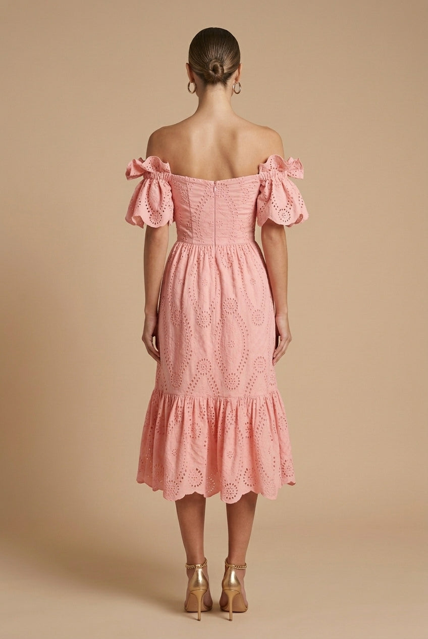 Woman showcasing a tailored-inspired dress with a sleek silhouette on a plain background.