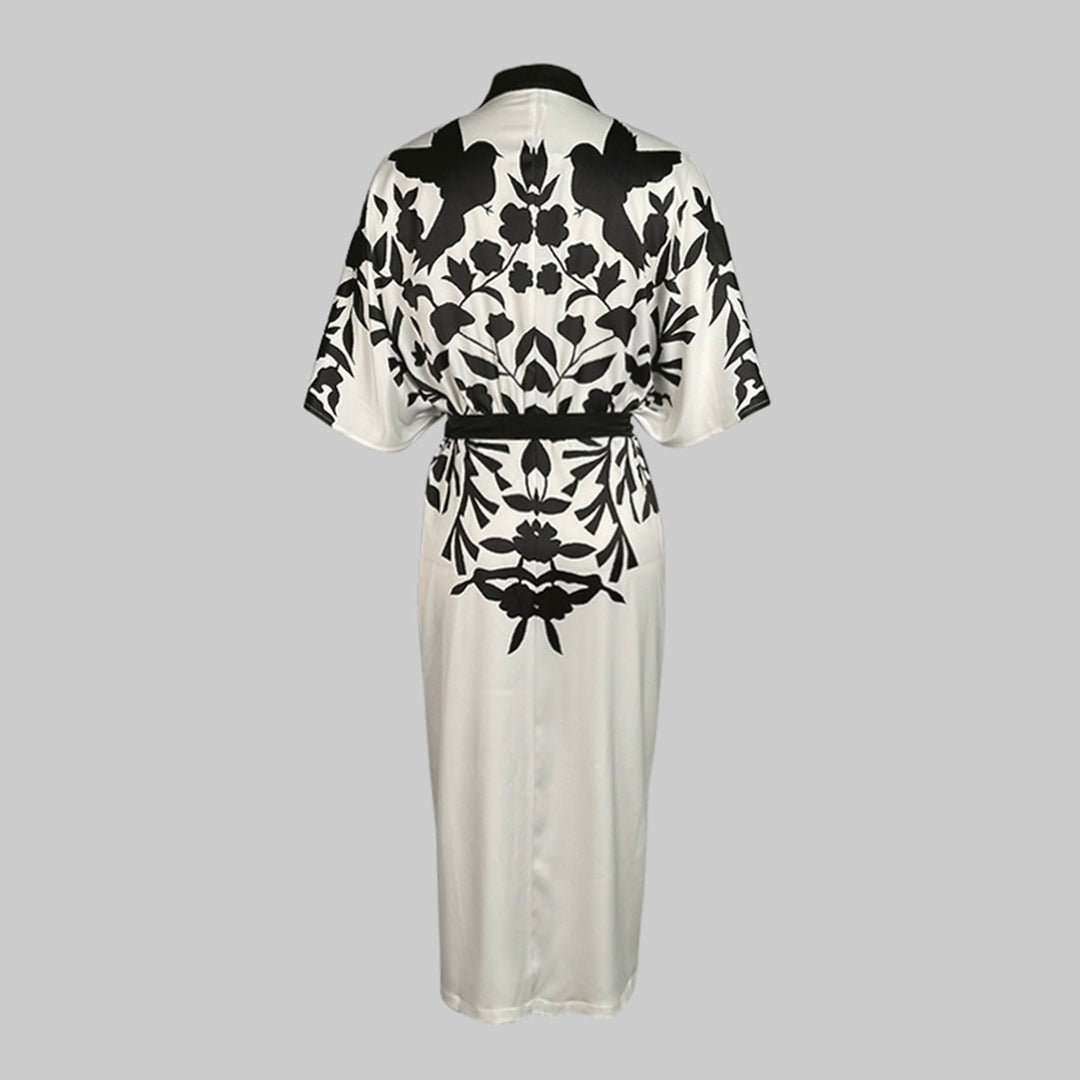 Floral print dress featuring batwing sleeves and front button detailing on a plain background.