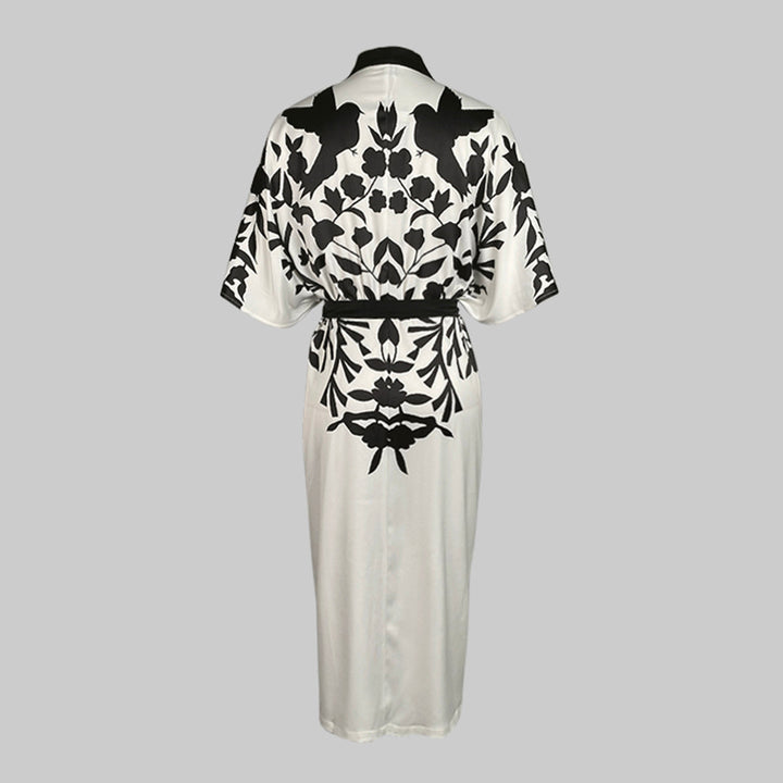 Floral print dress featuring batwing sleeves and front button detailing on a plain background.