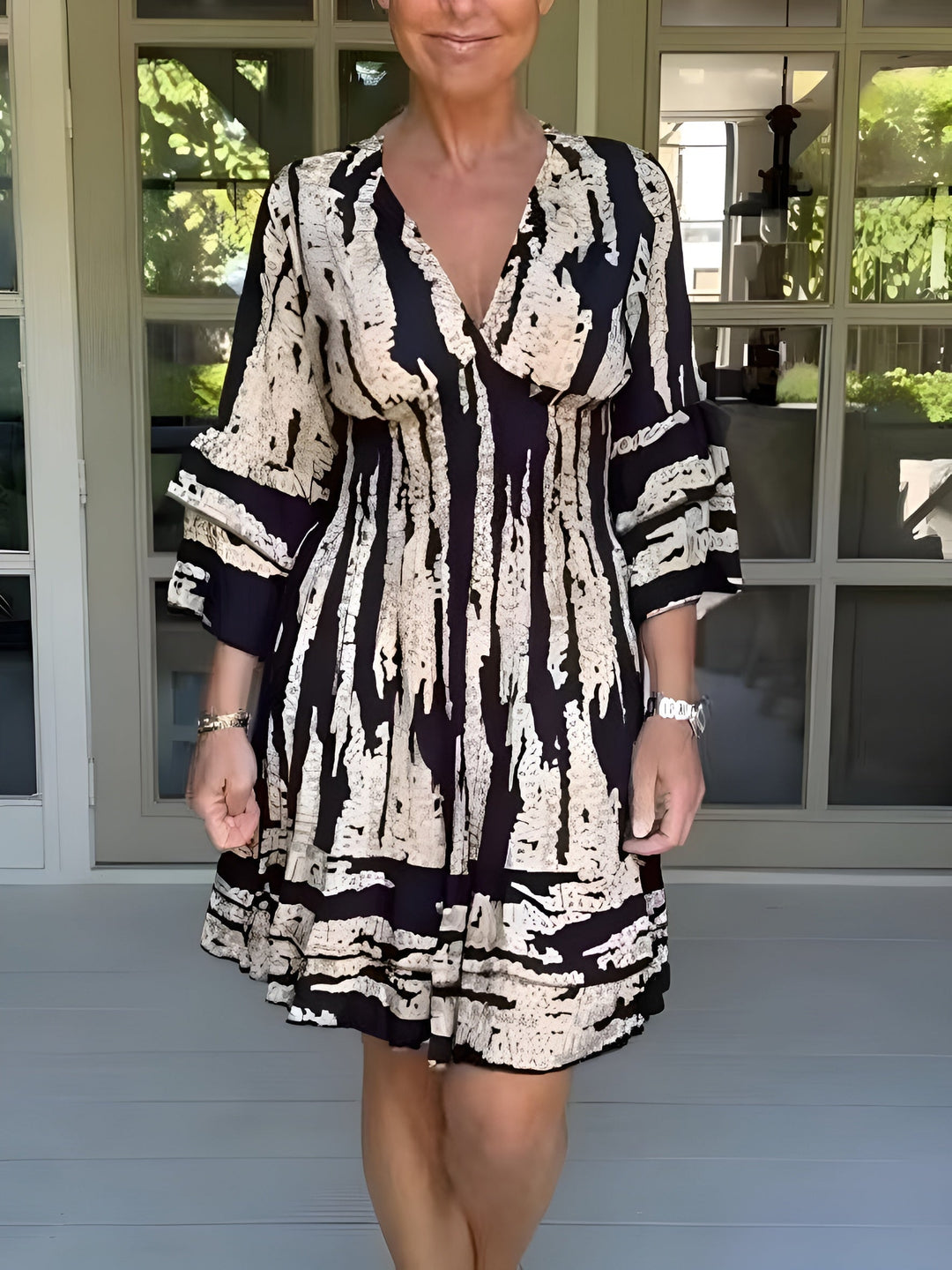 Woman wearing a flowing summer dress with a graceful silhouette.