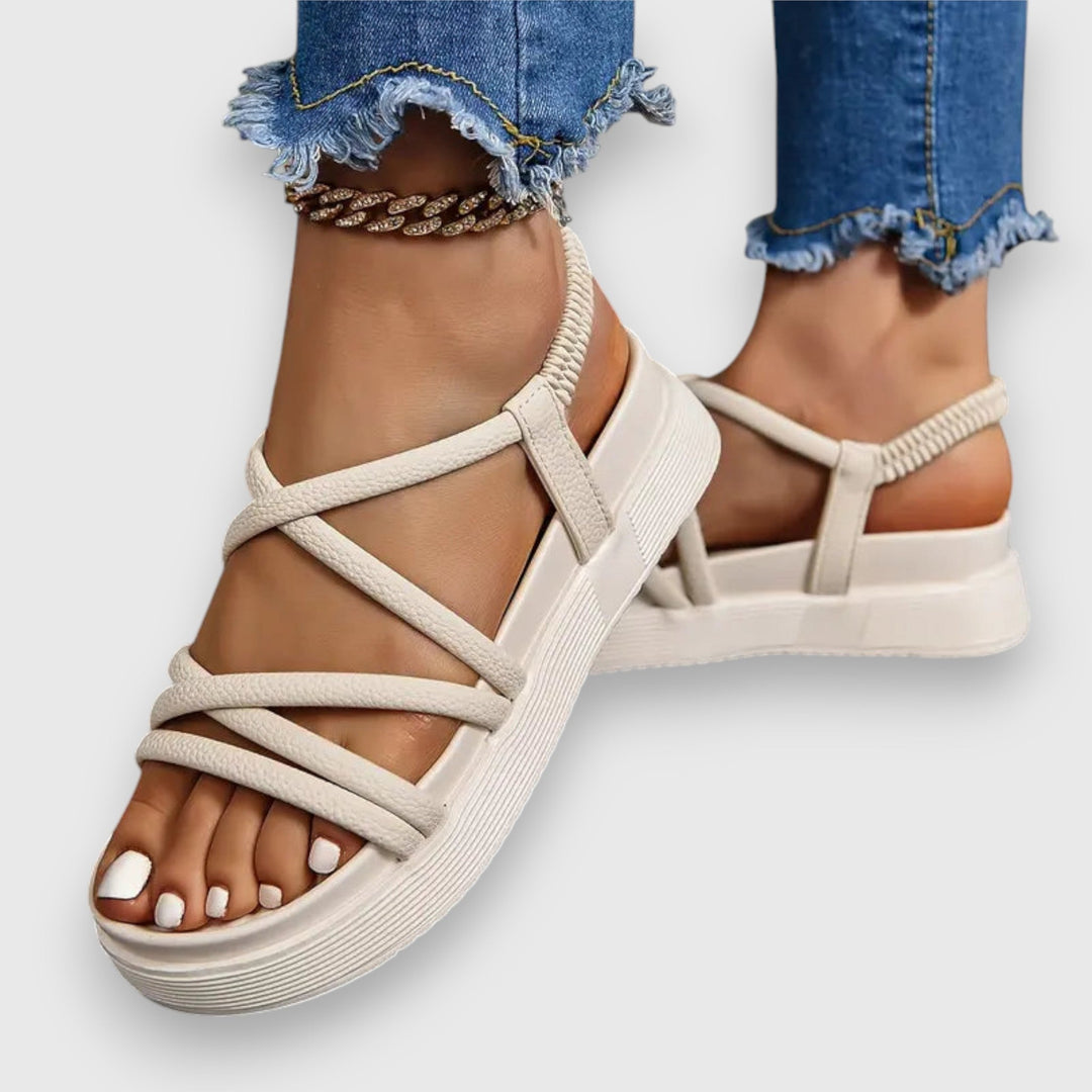 Women’s sandals shown on a female model against a plain background.