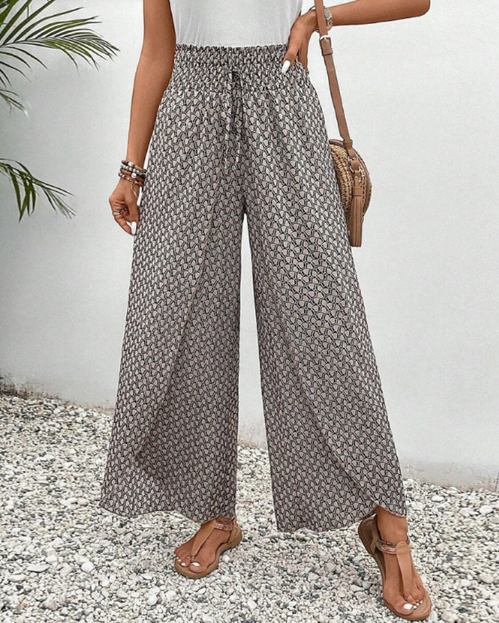 Wide-leg trousers displayed on a plain background with a relaxed flowing fit.