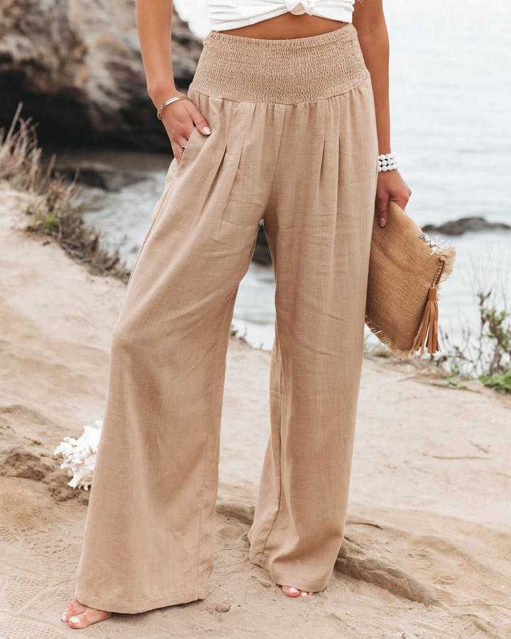 Flowy wide leg beach pants on a plain background for relaxed summer style.