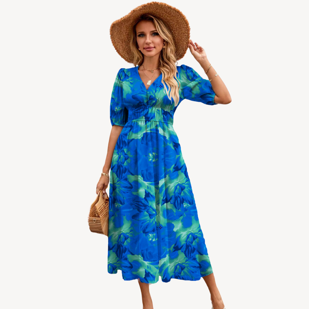 Woman wearing a floral print V-neck midi dress with tie waist on a plain background.