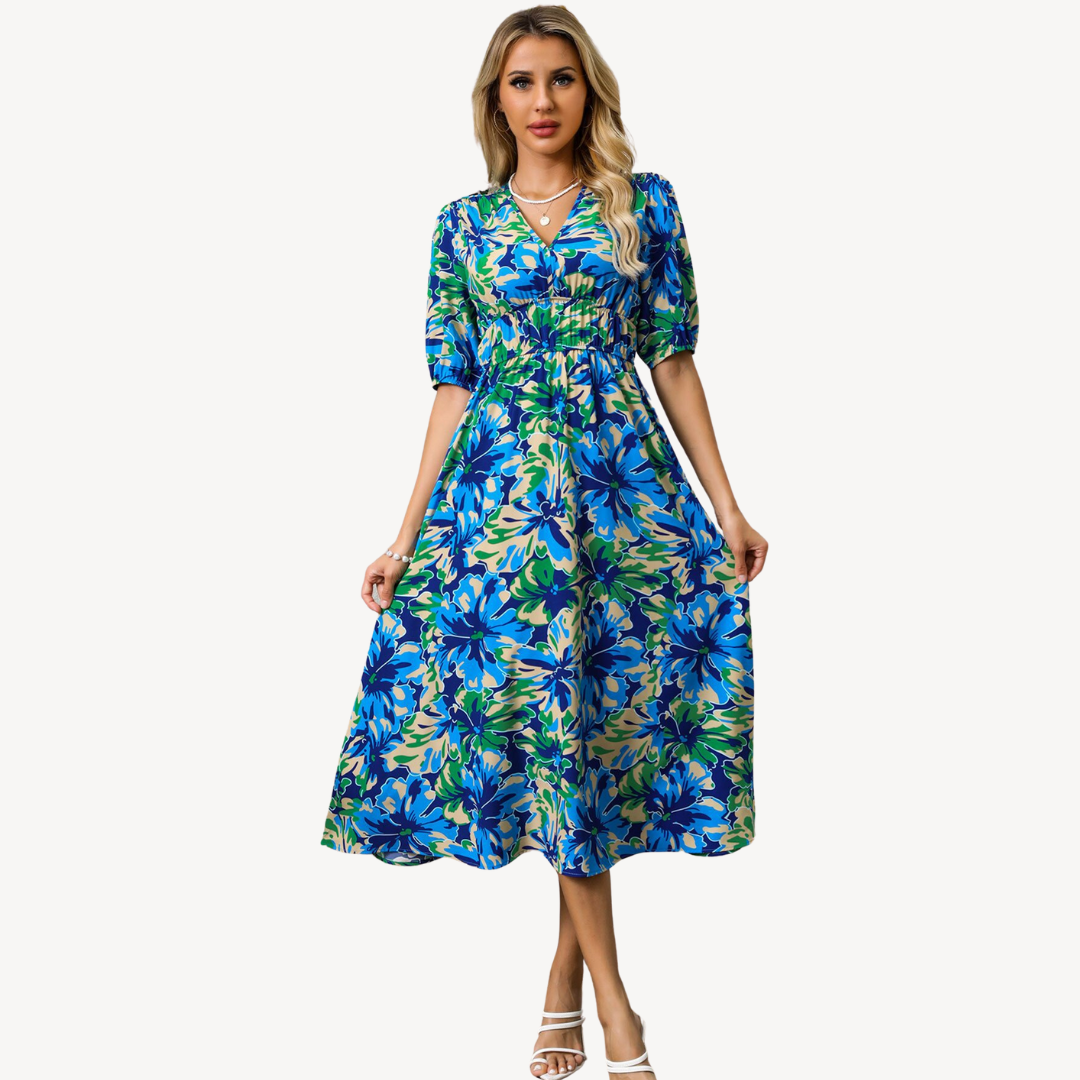 Model wearing a feminine floral midi dress with adjustable tie waist on a plain background.