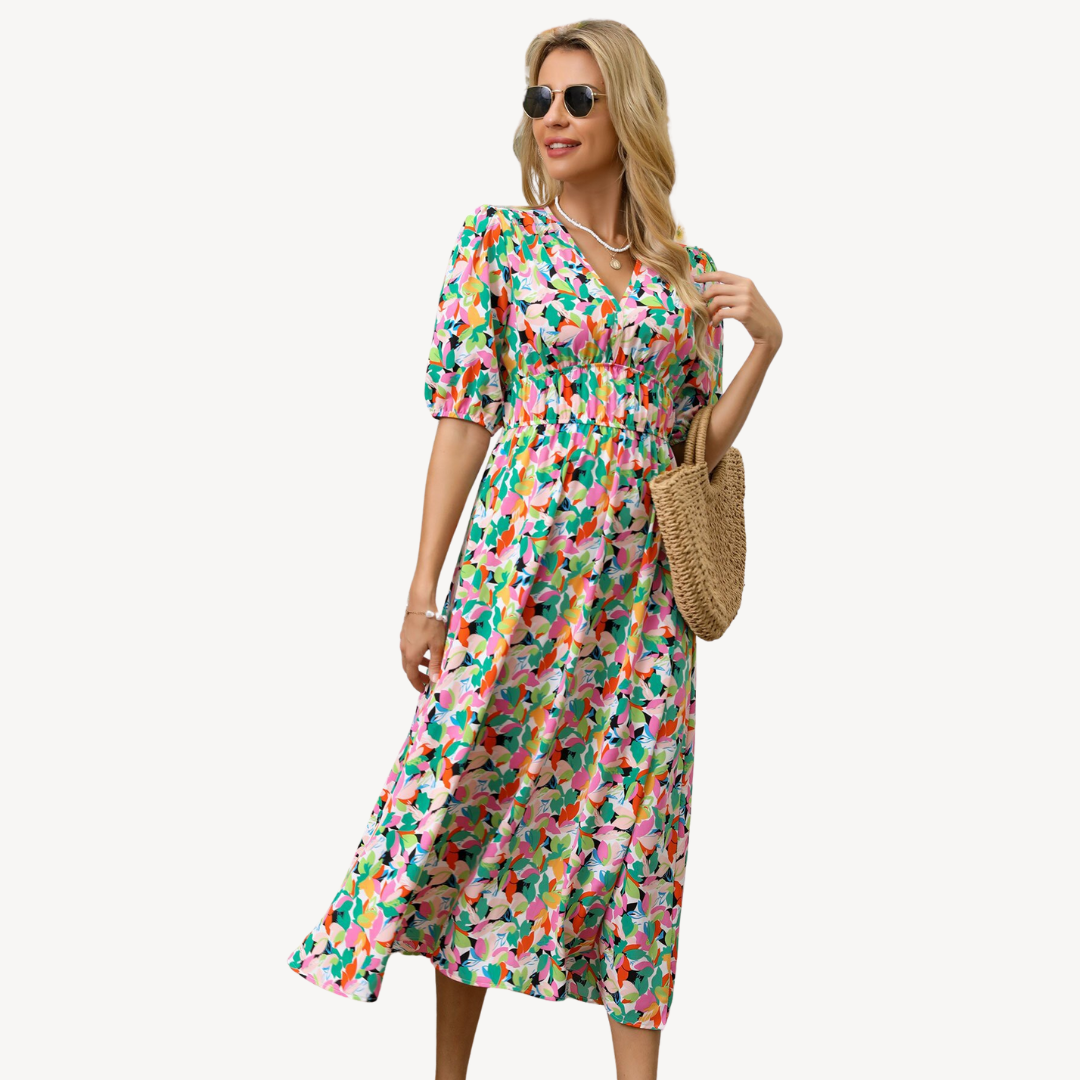 Woman showcasing a floral print midi dress with short puff sleeves on a clean background.