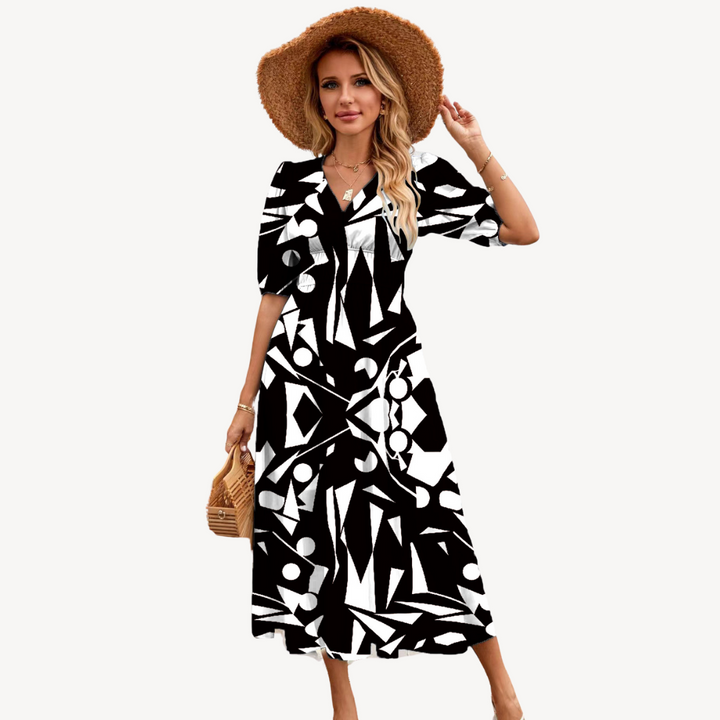 Female wearing a V-neck floral midi dress with flowing skirt against a plain background.