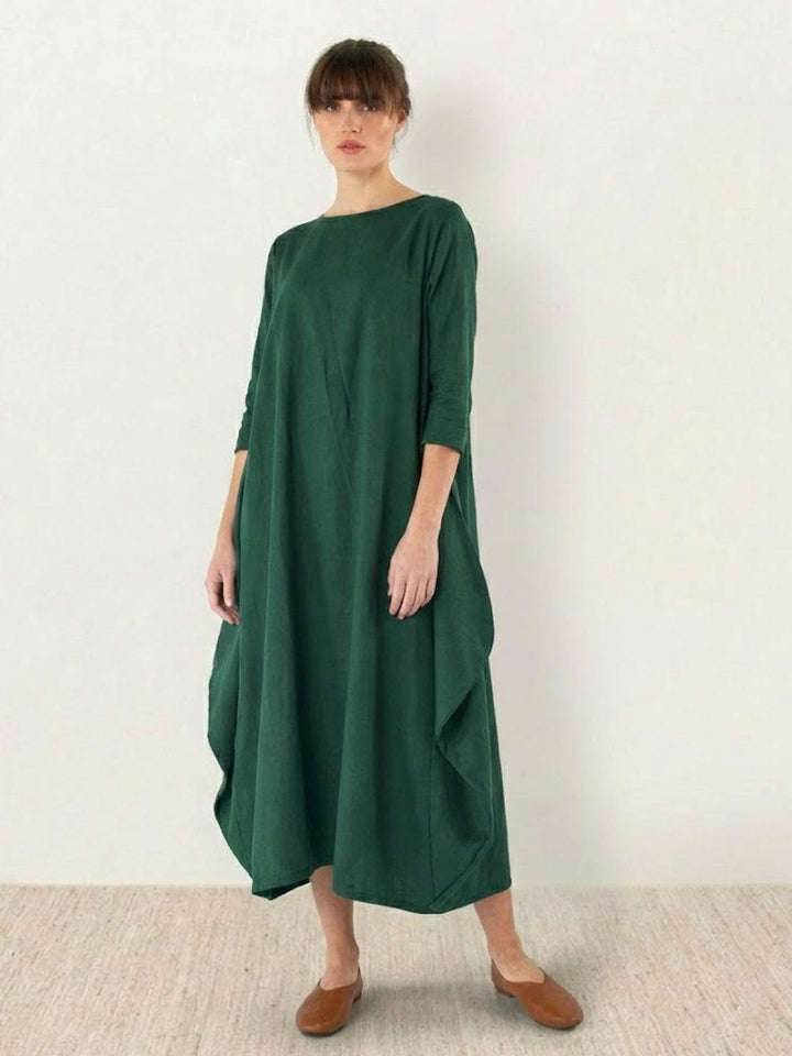 Casual maxi dress styled with simple fashion details on a plain background.