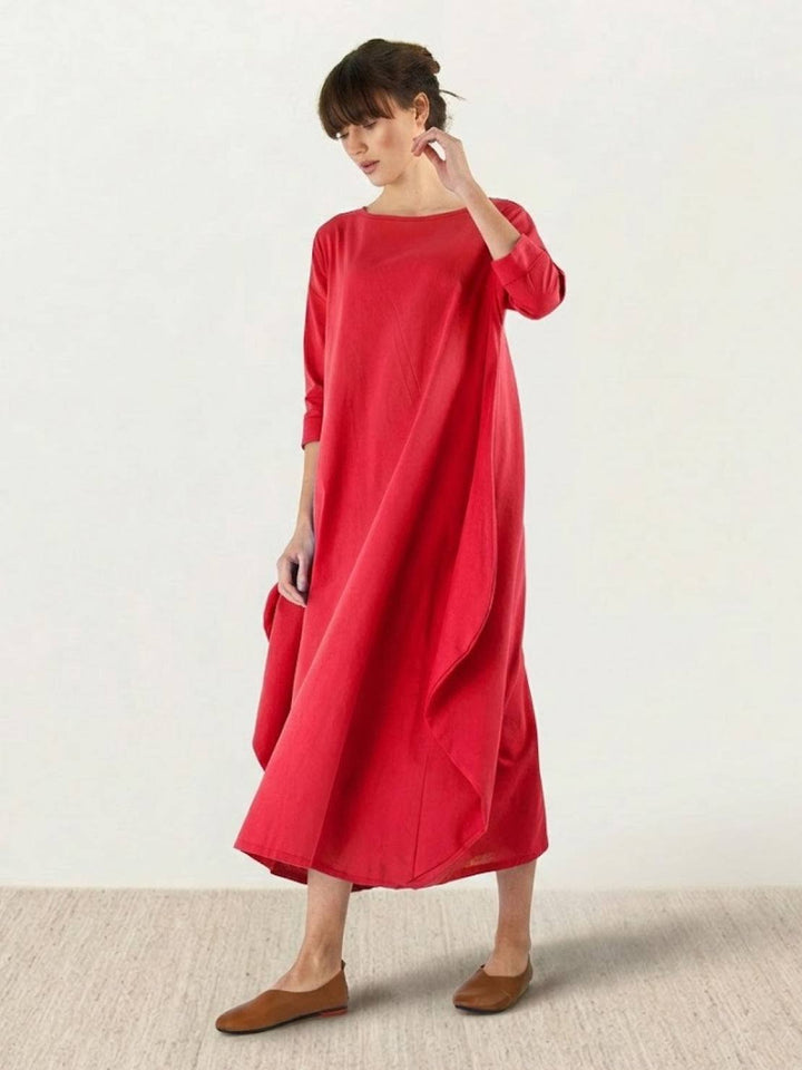 Female model showcasing a long relaxed dress with simple everyday styling.