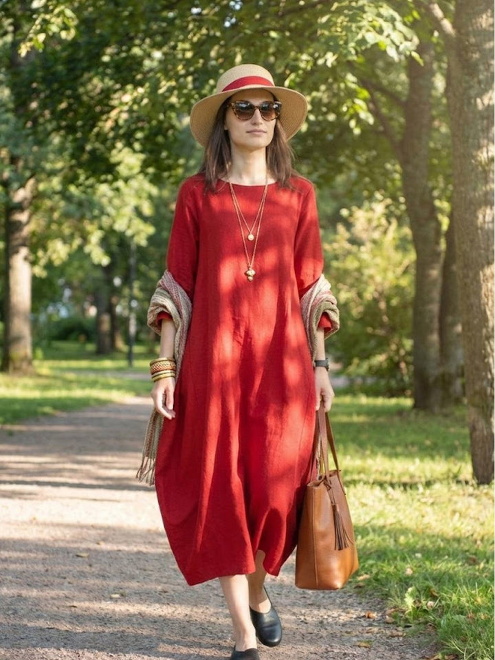 Long casual dress with relaxed movement displayed on a nature backdrop.