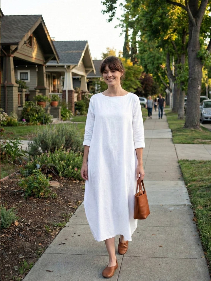 Woman wearing a casual long dress with relaxed sleeve design.