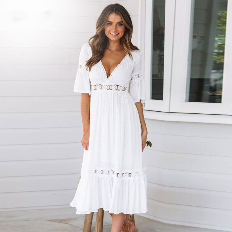 Female model wearing a printed midi dress against a plain background.