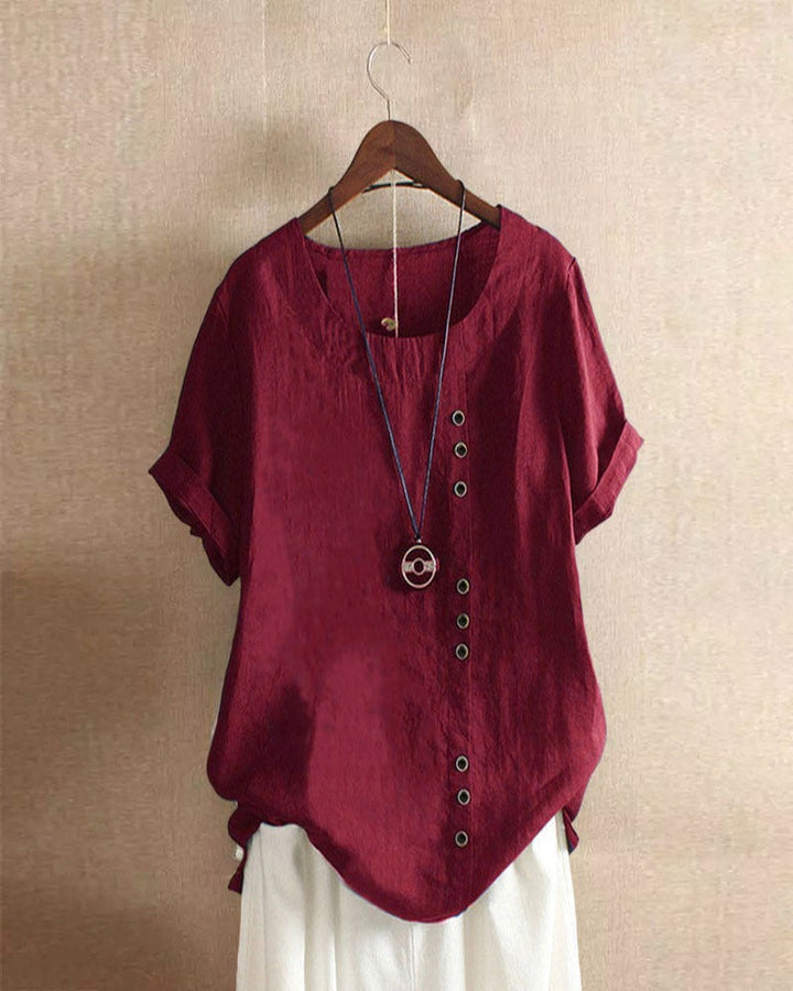 Relaxed fit blouse displayed from right angle plain background.