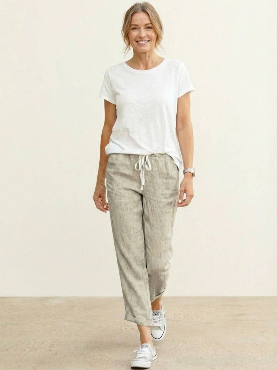 Easy women’s casual pants with adjustable waist and side pockets on a plain background.