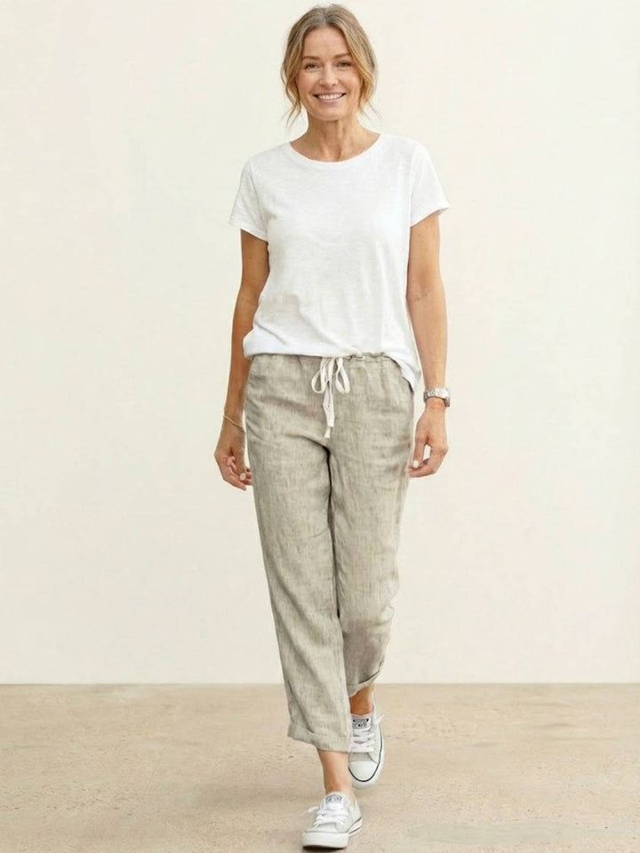 Easy women’s casual pants with adjustable waist and side pockets on a plain background.