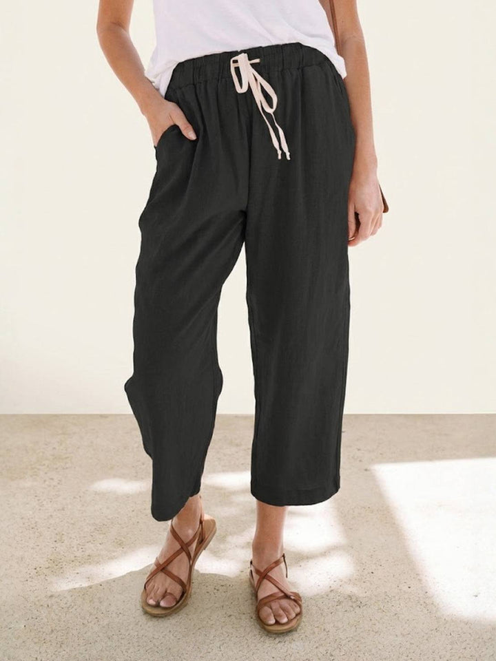 Women’s everyday drawstring trousers displayed on a plain background with a neat ankle finish.