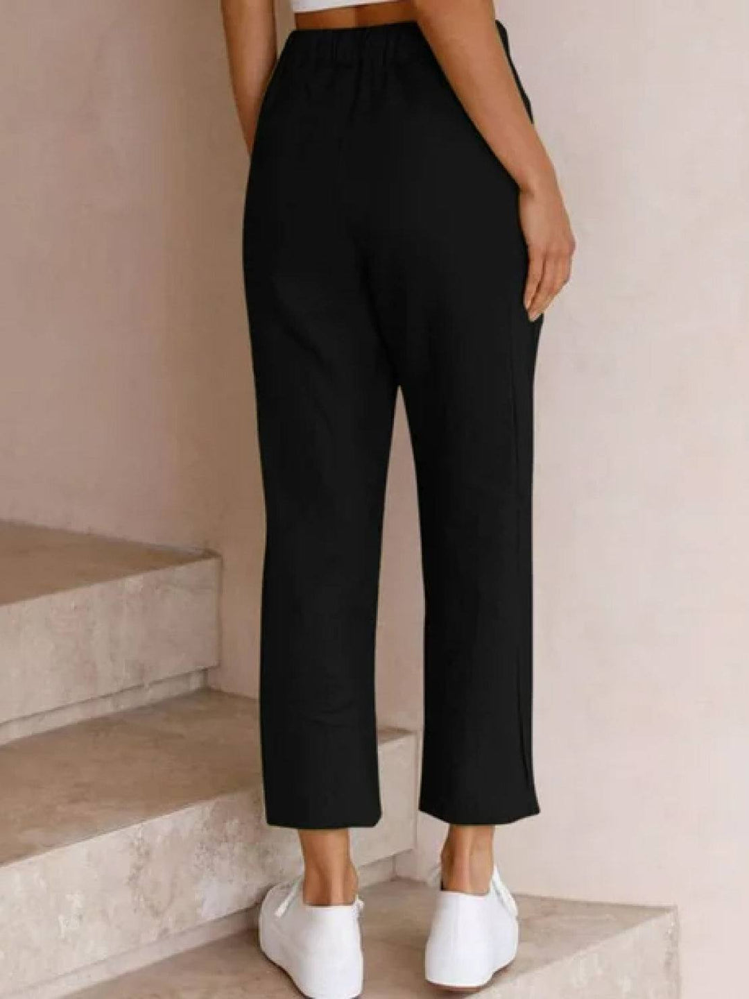 Relaxed women’s pants with elastic waistband and tapered legs shown on a plain background.