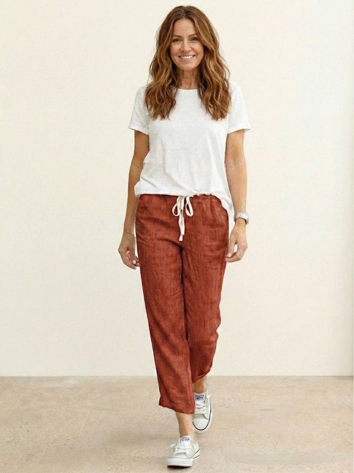 Everyday women’s tapered trousers displayed on a plain background with side pocket detail.