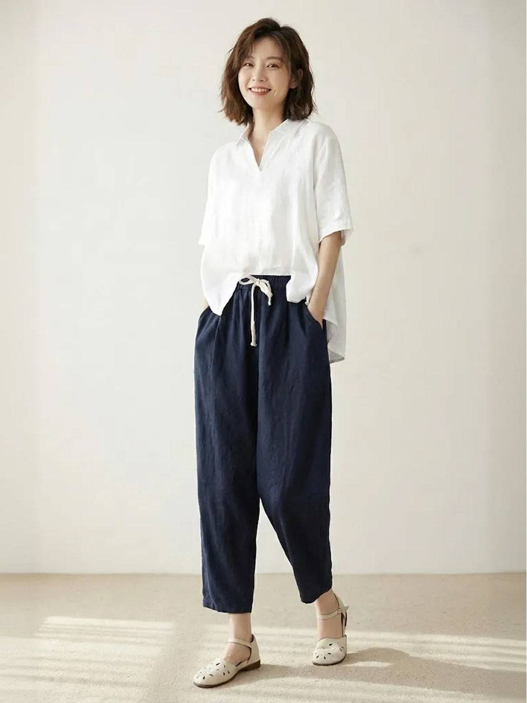 Women’s easy-fit pull-on pants shown on a plain background with practical side pockets.