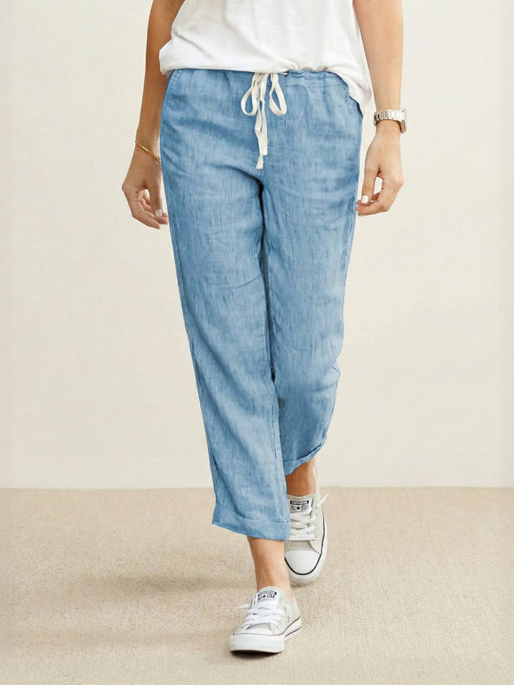 Casual women’s trousers with roomy hip fit displayed on a plain background.
