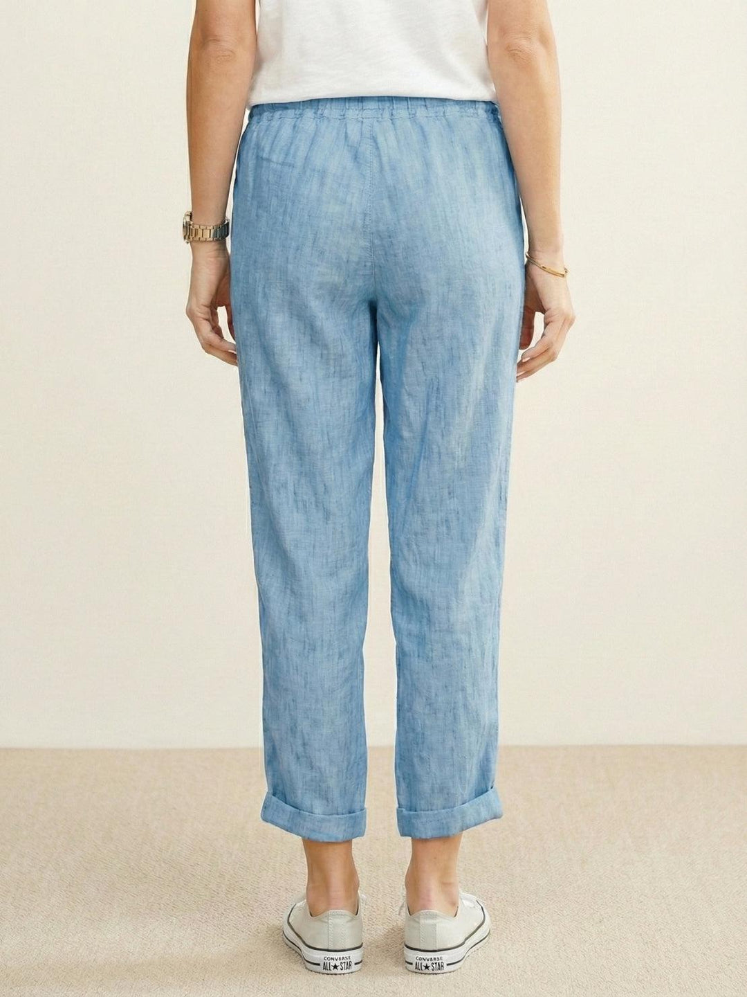 Women’s elastic waist tapered pants on a plain background for laid-back styling.