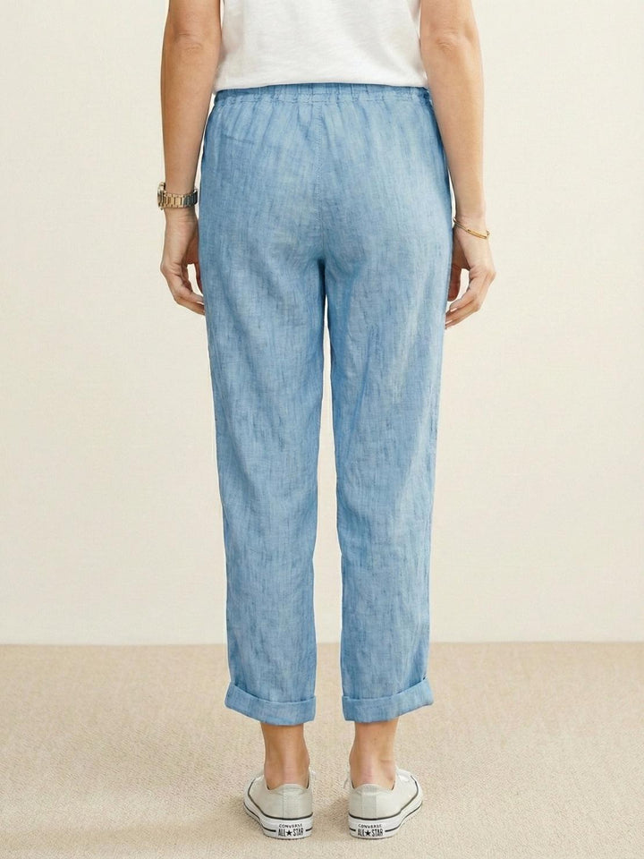 Women’s elastic waist tapered pants on a plain background for laid-back styling.