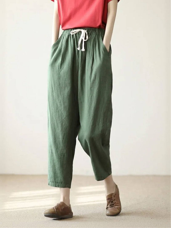 Women’s relaxed trousers with side pockets shown on a plain background.