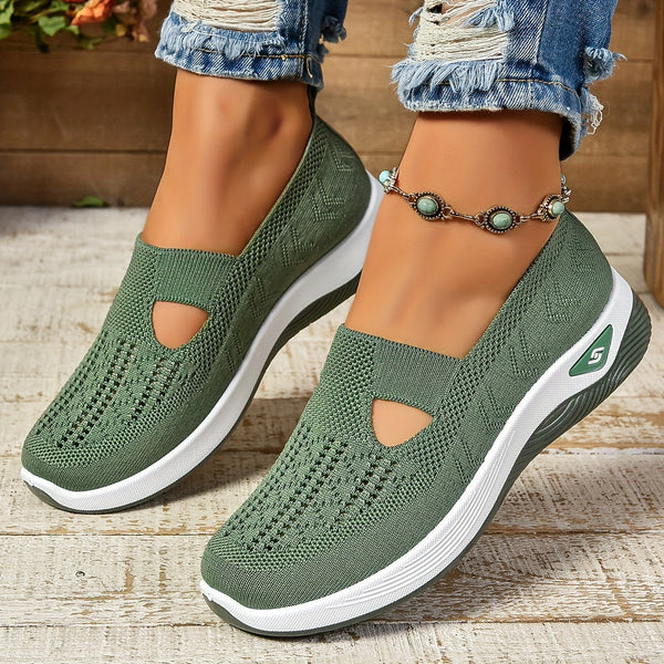 Female model wearing lightweight slip-on shoes against a plain background.