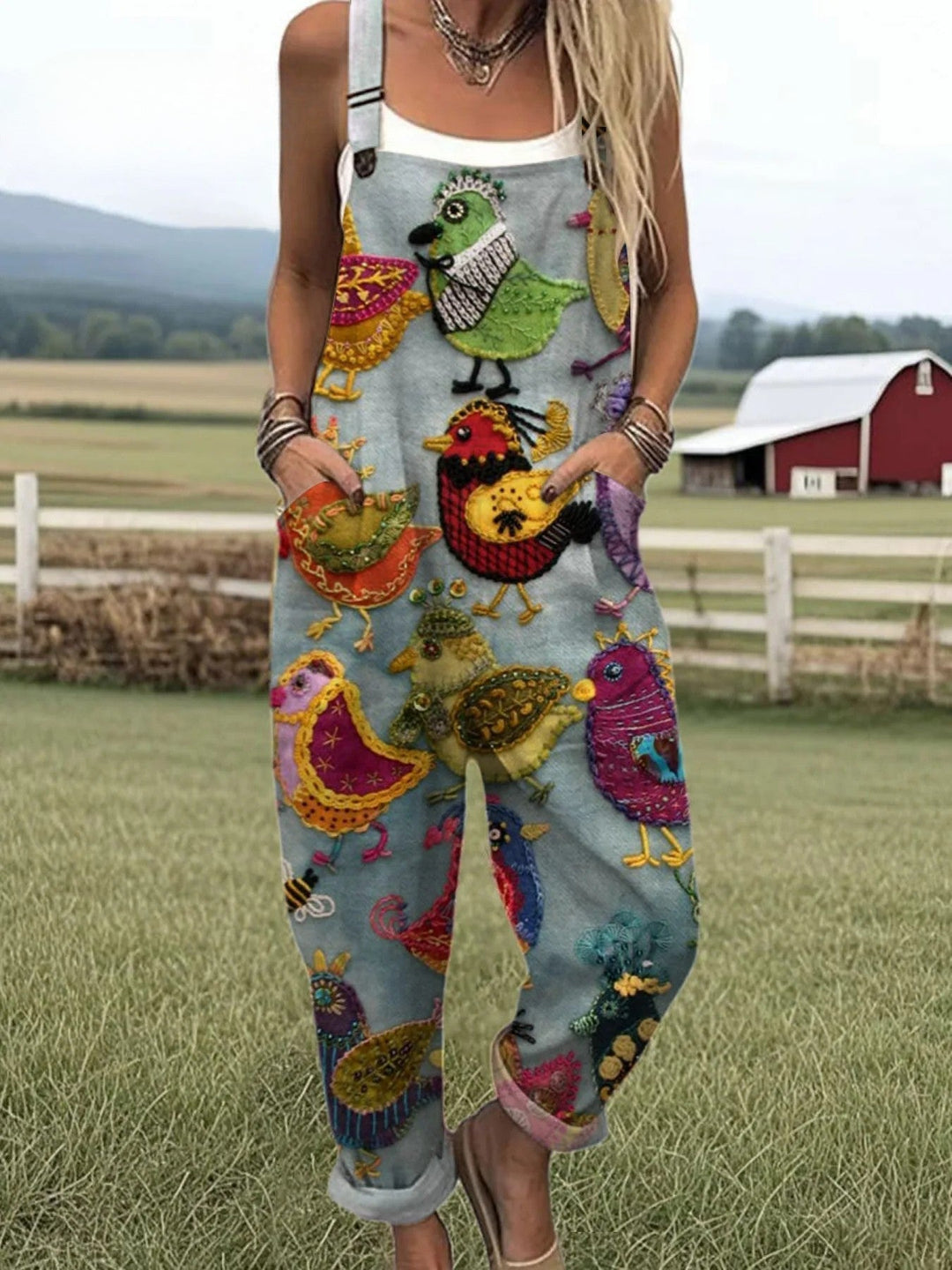 Female model wearing a colorful bird print jumpsuit against a plain background.